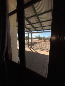 an open door to a porch with a view of a field at The Federal Hotel in Kalgoorlie