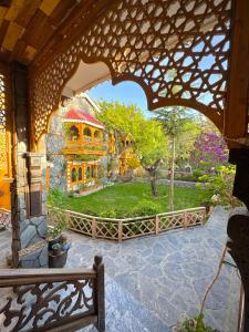 a view of a large house from an archway at Lavender Cottage and Guest House in Skardu