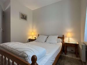 a bedroom with a large bed with two night stands at Maison 6 couchages à Oléron - Proche mer, jardin clos, WiFi, animaux admis, ménage inclus - FR-1-246A-299 in Saint-Georges-dʼOléron
