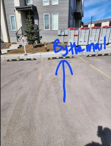 a street with a blue arrow painted on the road at Condo in Southeast Calgary in Calgary