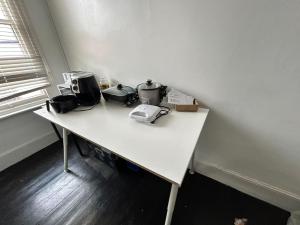 a white table with appliances on top of it at Rob Roy Room 1 in Adelaide