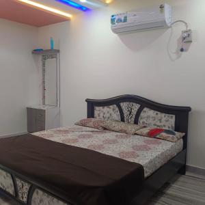 a bedroom with a bed and a air conditioner at Karthikeya villa’s in Narasaraopet
