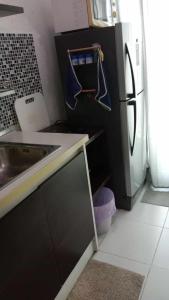 a kitchen with a sink and a refrigerator at Otto Stay BKK airport 10 mins, Near Malls & Night Market in Ban Khlong Lat Bua Khao
