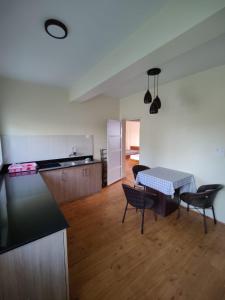 a kitchen and living room with a table and chairs at Home Stay Nunnery in Burhānilkantha +6 photos