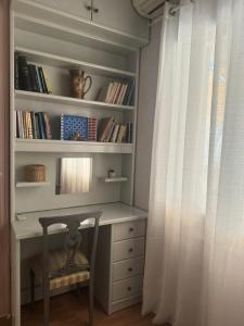 a room with a desk and a book shelf with a window at ATHENS CITY THEMIS 4 in Athens