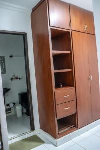 a wooden cabinet in a room with a mirror at Guajira Sunset Hostal in Ríohacha