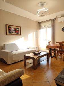 a living room with a couch and a table at Sandra's Apartment in Tirana Center in Tirana