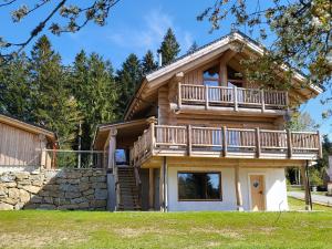 a log home with a deck and a balcony at Böhmerwald Lodges in Ulrichsberg