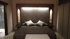 Posteľ alebo postele v izbe v ubytovaní Hotel La Brasa