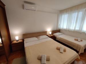 two beds in a room with two towels on them at Apartment Nadja in Split