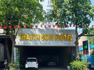 a car parked under a thank son hotel sign at Khách sạn Thanh Sơn Nội Bài in Hanoi