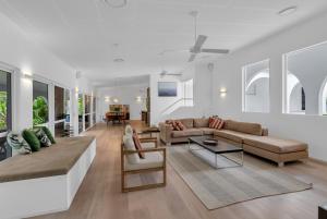 a living room with a couch and a table at Ohana Palm Cove in Palm Cove