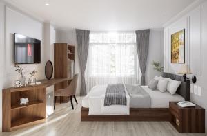 a bedroom with a bed and a desk and a television at Baglioni Signature in Ho Chi Minh City