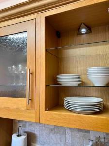 a cupboard with plates and dishes inside of it at King-size bed en- suit, Luxury refurbished home in Balderton