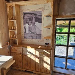 un mobile in legno con una foto sopra accanto a una finestra di Alice Chalet Bled a Bled