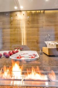 a kitchen with a pizza on a counter with flames at Sun Suite Luxury Pantheon in Rome
