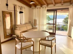 a living room with a table and chairs and a couch at OLIVIA LODGE in Sulzano