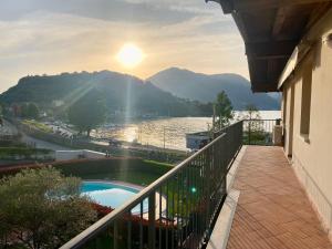 a balcony of a house with a view of the water at OLIVIA LODGE in Sulzano