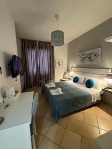 a bedroom with a large bed with blue pillows at San Pietro Otranto in Otranto