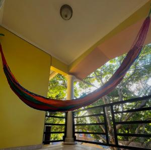 a room with a hammock in front of a window at Mango Hostel in Comayagua
