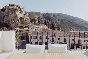a view of a building with mountains in the background at Olcina apartments in El Castell de Guadalest
