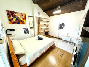 a small room with a bed and a dining room at Kyoto G in Kyoto