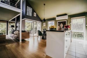 a kitchen and living room with a counter top at Boatshed Villa Yellow Door in Daylesford
