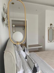a mirror sitting on top of a couch with pillows at Summer Dreams Studios in Skala Potamias