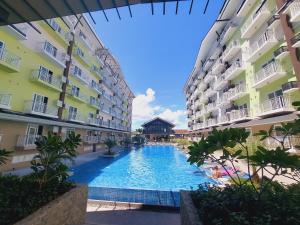 a swimming pool in the middle of two buildings at ANIA SUITE ROOM in Mactan