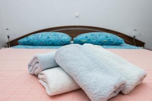 a bed with towels and pillows on it at Apartment RB in Omišalj +32 photos