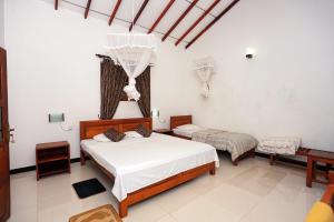 Postel nebo postele na pokoji v ubytování Scenic Cottage Sigiriya