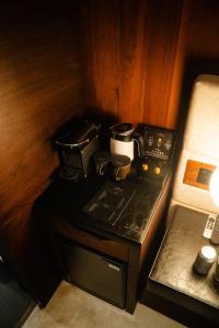 a small table with a coffee maker on it at Cave Hotel near Canterbury in Faversham