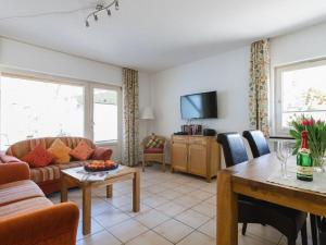 a living room with a couch and a table at House on the sunny slope type B in Eslohe