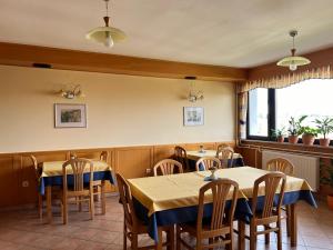 a restaurant with tables and chairs and a window at Mini Hotel in Škofja Loka