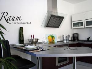 a kitchen with a table with plates and wine glasses at Living Lust 2 in Malchow in Malchow