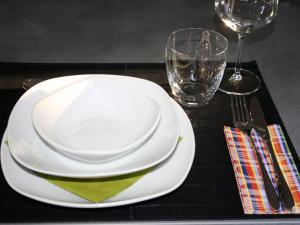a table with two white plates and a wine glass at Living Lust 2 in Malchow in Malchow
