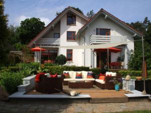 a house with a patio with couches in front of it at Living Lust 2 in Malchow in Malchow