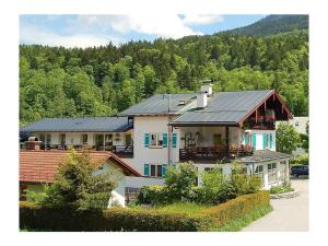 a large white house with a black roof at Vakantieappartement in Berchtesgaden