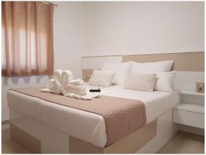 a bedroom with a large bed with white sheets and pillows at Villa Sabun Luxury Villa with Poo, Jacuzzi in Privlaka