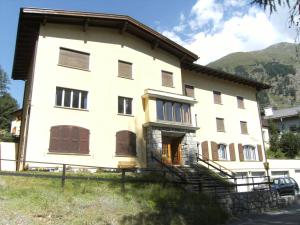 a large white house with a mountain in the background at Chesa Muragls in Pontresina