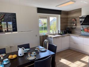 a kitchen with a table and a dining room at Beachvilla Ijsselmeerblik in Makkum