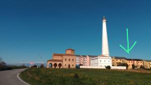 a building with a lighthouse next to a road at Il porto di Iskra in Vasto