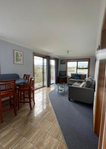 a living room with a couch and a table at Sunset Holiday Villas in Arthur River