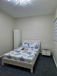 a bedroom with a bed and a ceiling fan at S & R Homes in Tacloban