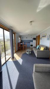 a living room with a couch and a table at Sunset Holiday Villas in Arthur River