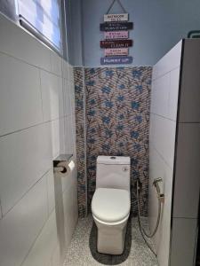 a small bathroom with a toilet in a stall at S & R Homes in Tacloban