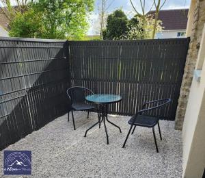 a table and two chairs and a table and chairs at Hébergement avec SPA privatif in Loos-en-Gohelle