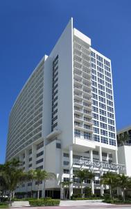 a large white building with a sign on it at Grand Beach Hotel in Miami Beach