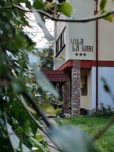 a building with a sign that reads villa lib gate at La Gabi in Azuga