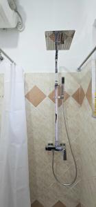 La salle de bains est pourvue d'une douche avec un pommeau de douche. dans l'établissement Joen Guesthouse, à Saranda